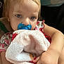Raven is registered to the contest to win money with this photo: toddler, child, pacifier, blanket, soft_toy, stuffed_animal, blue_pacifier, face, hand, sleepy, cute, indoor, clothing, pink, red, comfort, closeup, person, young_child, expression