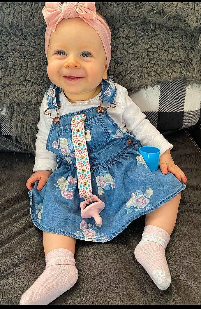 Everlyn joined the competition — help win amazing prizes! baby_toddler_clothing, cap, doll, dress, electric_blue, eye, face, happy, head, headgear, headwear, iris, joy, pattern, person, pink, skin, sleeve, smile, textile