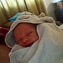 Danté is registered to the contest to win money with this photo: baby, towel, hood, sleepy, wrapped, blanket, indoor, curtain, basket, soft, child, face, cozy, comfort, person, fabric, home, newborn, resting, cute