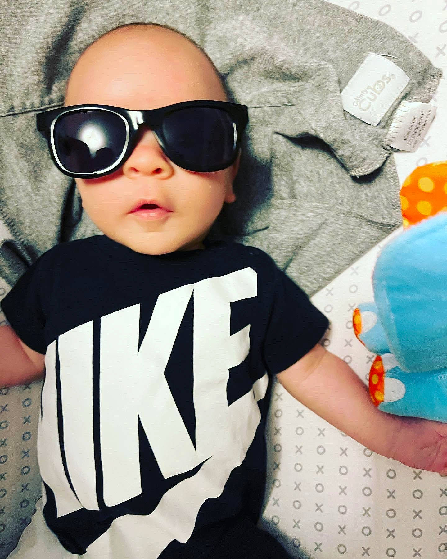 Chase is registered to the contest to win money with this photo: baby_toddler_clothing, clothing, eyewear, facial_expression, fashion, glasses, goggles, hairstyle, human, lip, neck, outerwear, person, product, sleeve, street_fashion, sunglasses, t_shirt, textile, vision_care