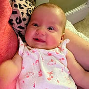 Everleigh joined the competition — help win amazing prizes! baby, smile, infant, person, clothing, arm, indoor, onesie, pattern, pink, white, cute, happy, child, newborn, face, skin, holding, comfort, expression