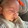 Everleigh is registered to the contest to win money with this photo: baby, sleeping, headband, orange_bow, blanket, cushion, infant, closeup, face, skin, peaceful, cozy, newborn, child, soft_light, indoor, portrait, cute, resting, comfort