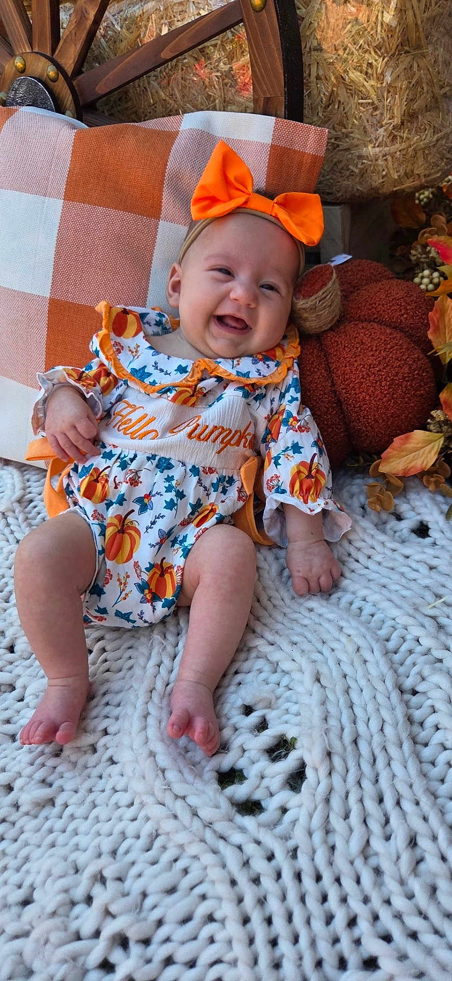 Everleigh joined the competition — help win amazing prizes! baby, infant, smiling, orange_bow, pumpkin_outfit, plush_pumpkin, knit_blanket, checkered_pillow, fall_decor, autumn, happy, child, headband, sitting, cute, person, indoors, decorative, cozy, festive