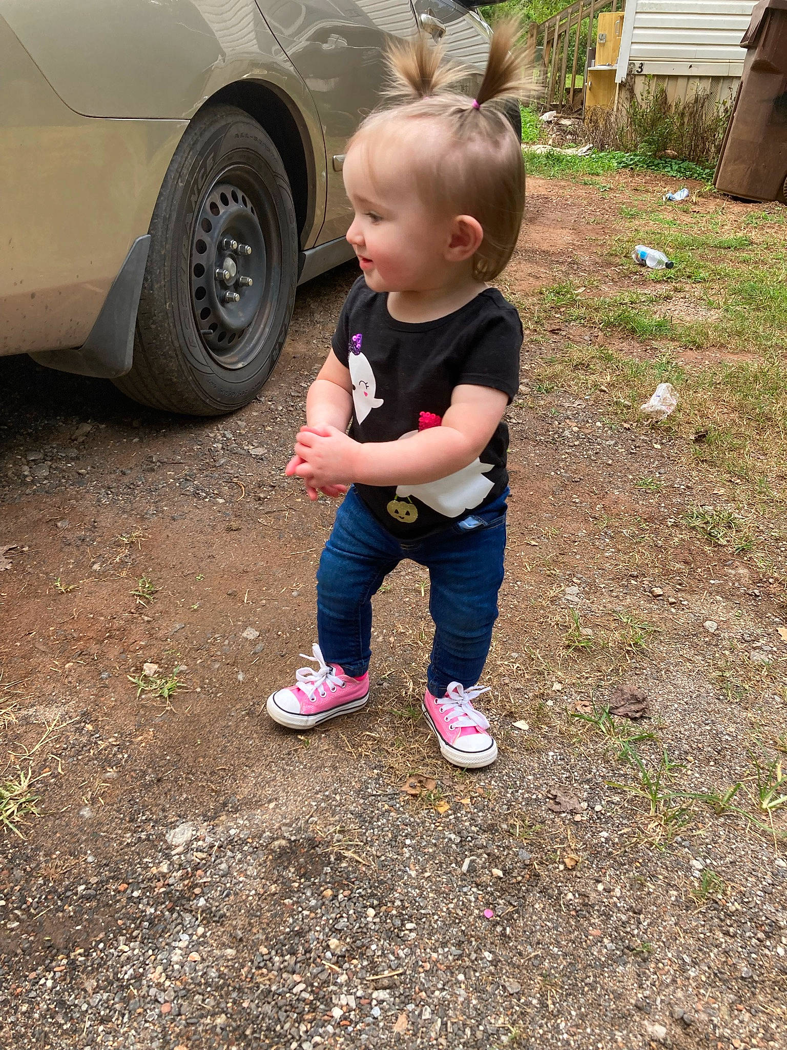 Paisley is registered to the contest to win money with this photo: asphalt, automotive_exterior, automotive_tire, car, child, fender, grass, motor_vehicle, people_in_nature, person, plant, rim, road_surface, tints_and_shades, tire, toddler, tree, vehicle, vehicle_door, wheel