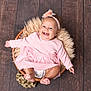 baby, child, smiling, pink_dress, headband, basket, fluffy_blanket, wooden_floor, happy, infant, portrait, cute, sitting, indoors, people, toddler, feet, hands, face, fashion