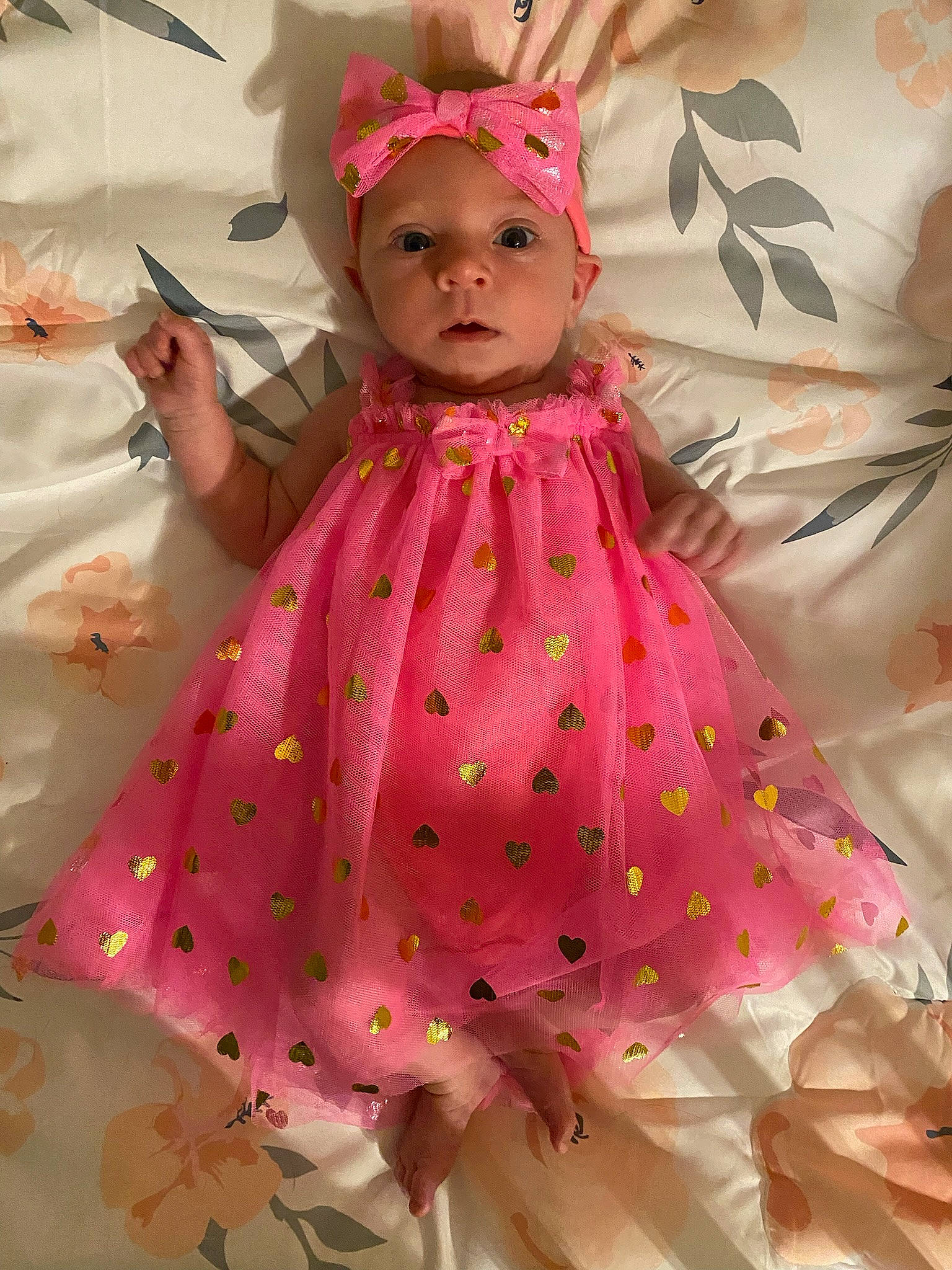 Brynn is registered to the contest to win money with this photo: baby, baby_toddler_clothing, cheek, child, day_dress, doll, dress, event, fashion_design, headwear, magenta, one_piece_garment, pattern, peach, person, petal, pink, skin, sleeve, textile