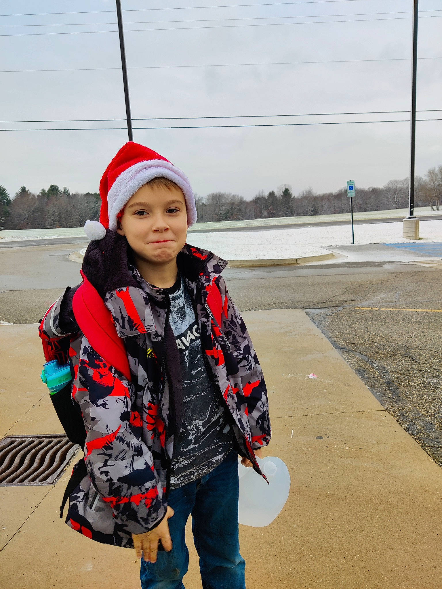 Tristen is registered to the contest to win money with this photo: asphalt, child, denim, fashion_accessory, freezing, fun, happy, headgear, headwear, jeans, landscape, leisure, pattern, person, personal_protective_equipment, recreation, road_surface, sky, sleeve, toddler