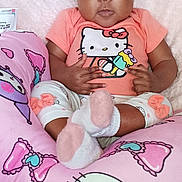 Amyna is registered to the contest to win money with this photo: apparel, baby, blanket, child, clothing, comfort, cushion, cute, decor, expression, headband, hello_kitty, indoor, infant, person, pink, portrait, seated, socks, soft_texture