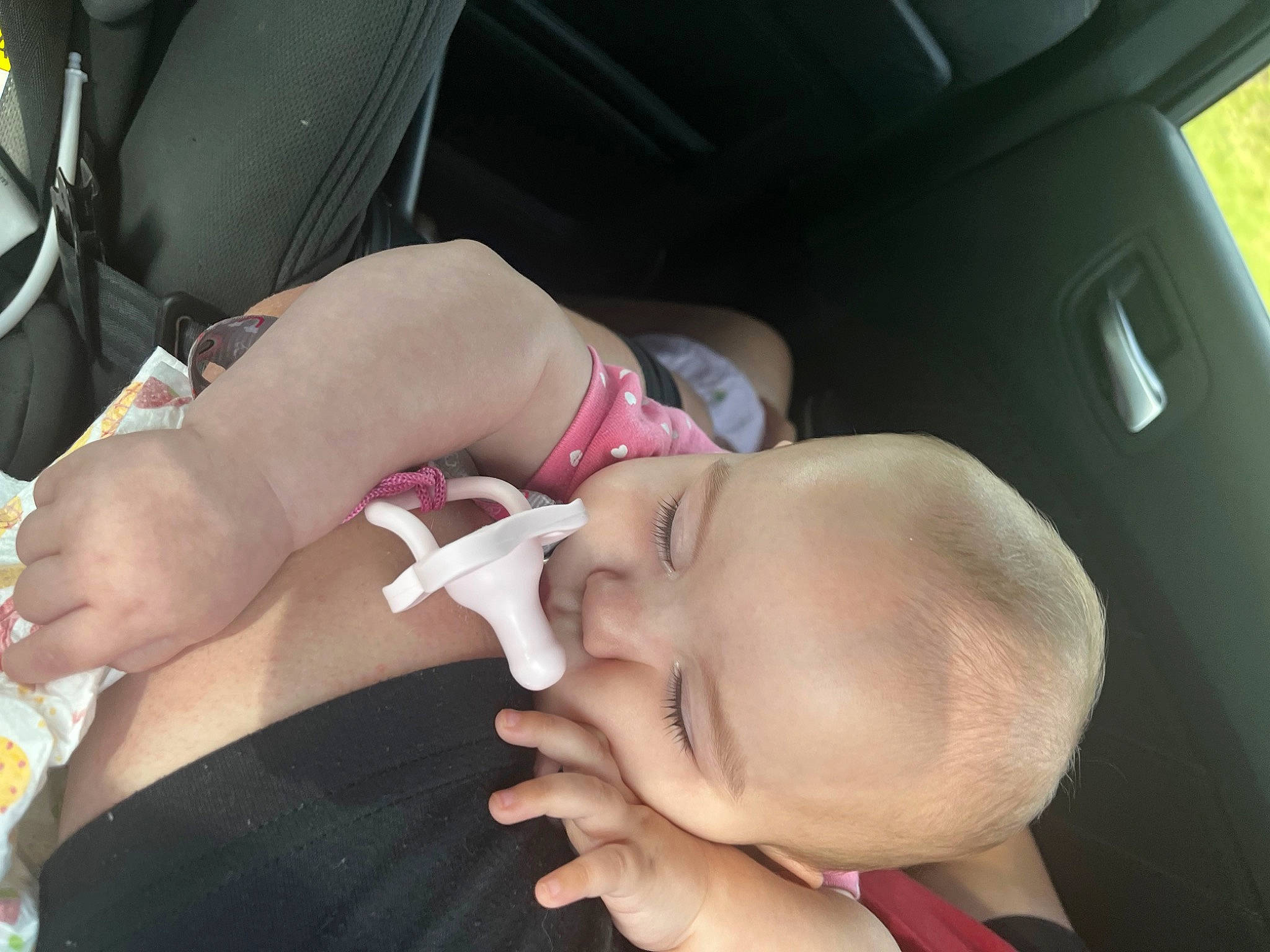Lovie is registered to the contest to win money with this photo: abdomen, baby, chest, comfort, elbow, eyelash, fun, gesture, glasses, happy, human_leg, knee, mouth, nail, person, thigh, thumb, toddler, trunk, vehicle_door