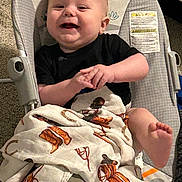 Cole joined the competition — help win amazing prizes! baby, baby_rocker, black_shirt, blanket, carpet, child, comfort, cute, fabric, face, foot, hand, happy, indoor, infancy, infant, pattern, portrait, seated, smiling