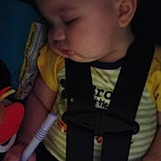 Parker is registered to the contest to win money with this photo: baby, black, car_seat, child, closeup, clothing, cute, face, hand, indoor, infant, naptime, peaceful, portrait, rest, seatbelt, sleeping, toy, yellow, young