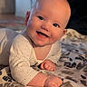 baby, child, infant, smiling, happy, portrait, crawling, sitting, indoors, bedroom, bed, blanket, bedspread, onesie, clothing, face, eyes, hands, warm_lighting, adorable