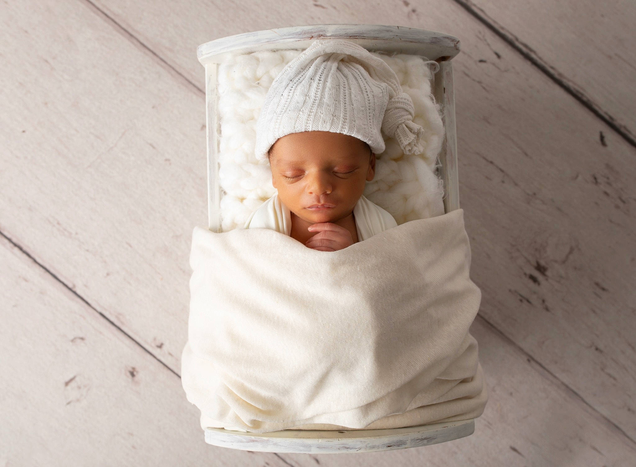 Cedric is registered to the contest to win money with this photo: baby, beige, bonnet, child, headgear, linens, person, product, sleeve, textile