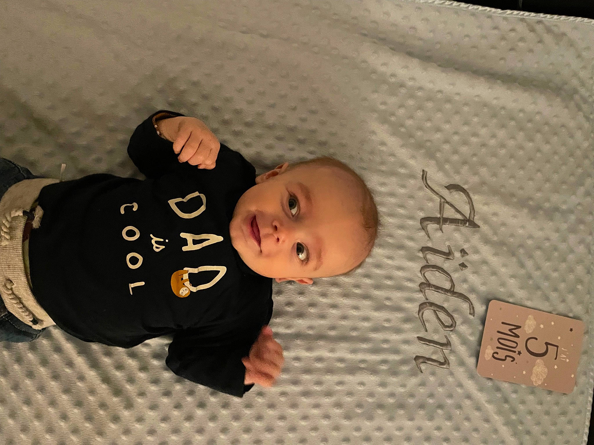 Aïden participe au concours pour gagner de l'argent avec cette photo : baby, baby_toddler_clothing, cheek, child, comfort, eye, flooring, font, handwriting, happy, linens, pattern, person, product, sleeve, smile, toddler, tree, wood