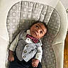 baby, infant, child, vest, bow_tie, clothing, pattern, baby_rocker, furniture, curly_hair, looking_up, skin, hand, feet, cute, indoors, portrait, relaxing, small, adorable
