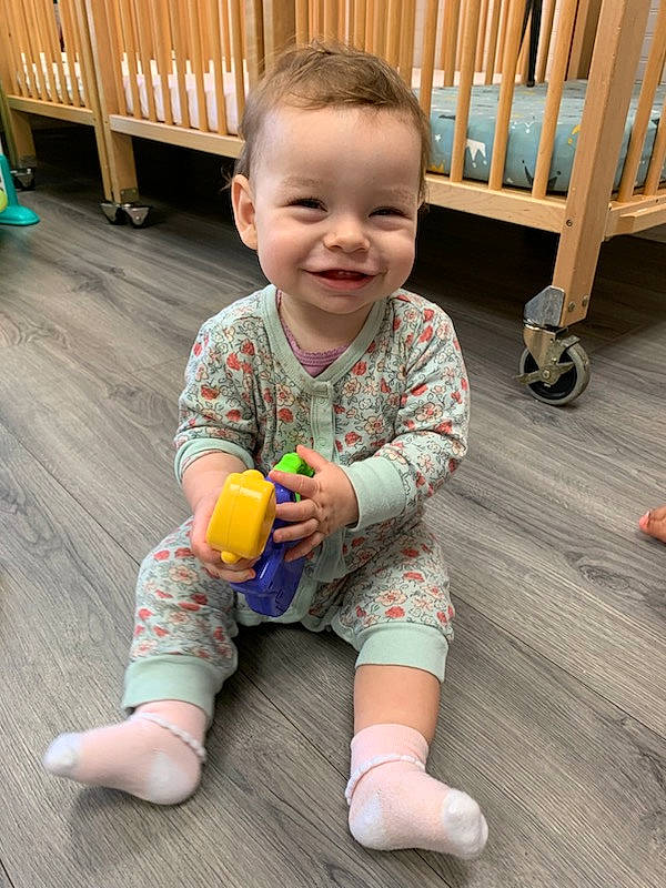 Myah is registered to the contest to win money with this photo: baby_toddler_clothing, cheek, clothing, face, facial_expression, floor, flooring, happy, head, human_body, iris, joint, joy, leg, person, skin, sleeve, smile, standing, toddler