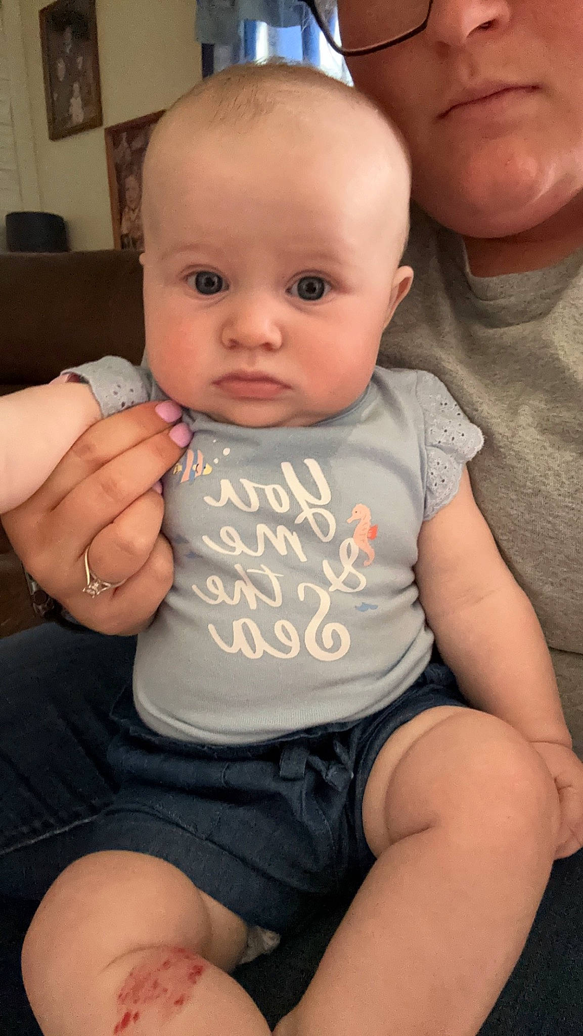 Mackenzie is registered to the contest to win money with this photo: arm, baby, baby_toddler_clothing, cheek, chin, eye, finger, gesture, hand, head, human_body, joint, leg, lip, mouth, muscle, neck, organ, person, shoulder
