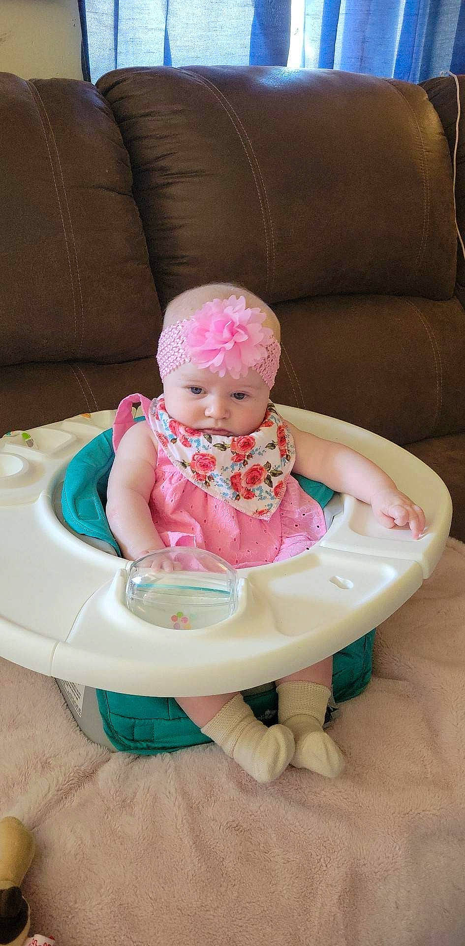 Mackenzie joined the competition — help win amazing prizes! baby, baby_carriage, baby_products, baby_safety, baby_toddler_clothing, cap, cheek, child, clothing, comfort, couch, face, fashion_accessory, head, headwear, magenta, person, pink, product, skin
