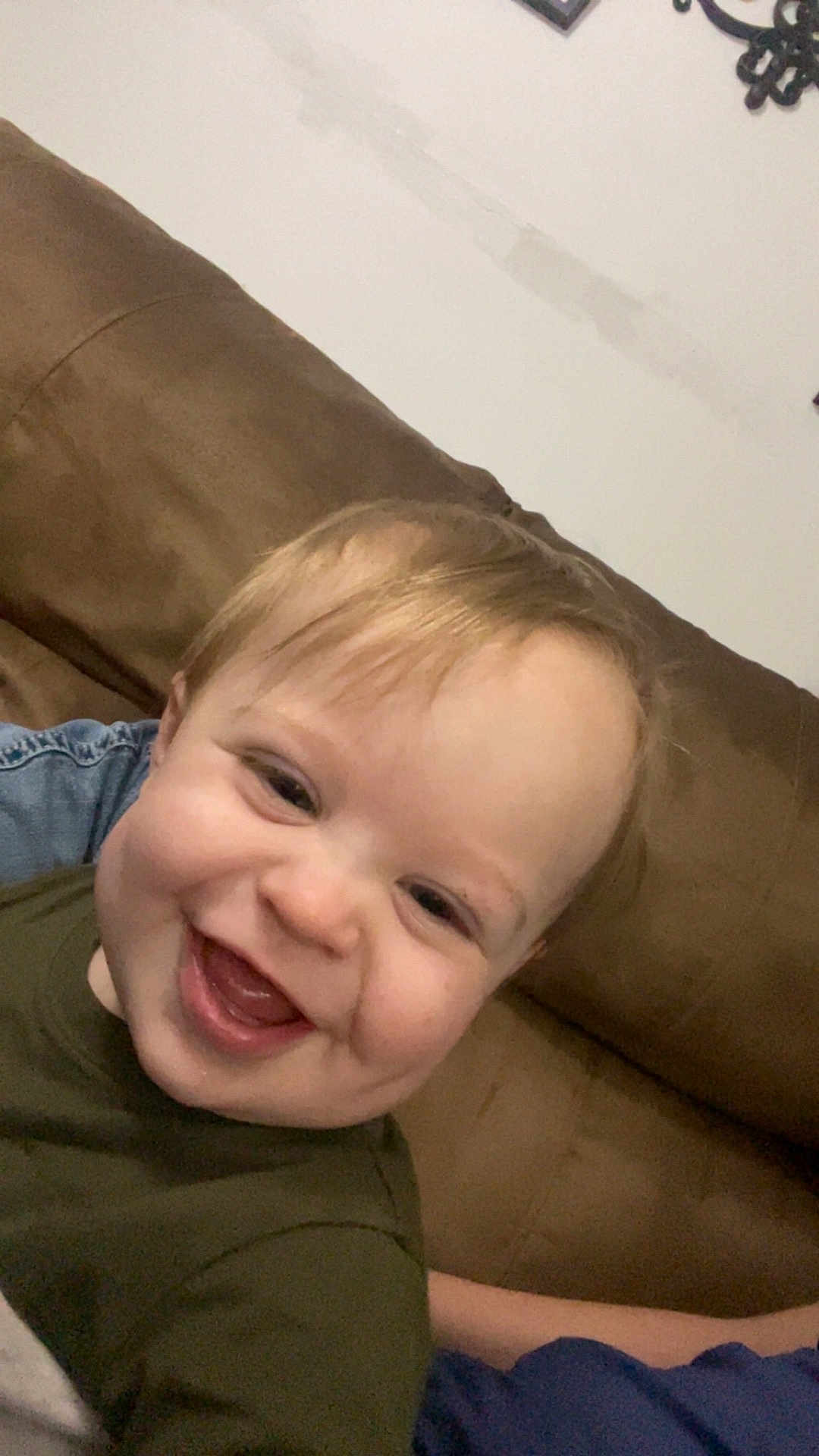 Kayce is registered to the contest to win money with this photo: baby, smiling, child, face, couch, indoor, happy, person, blond_hair, young, casual_clothing, closeup, portrait, infant, toddler, skin, cheerful, head, seated, relaxed