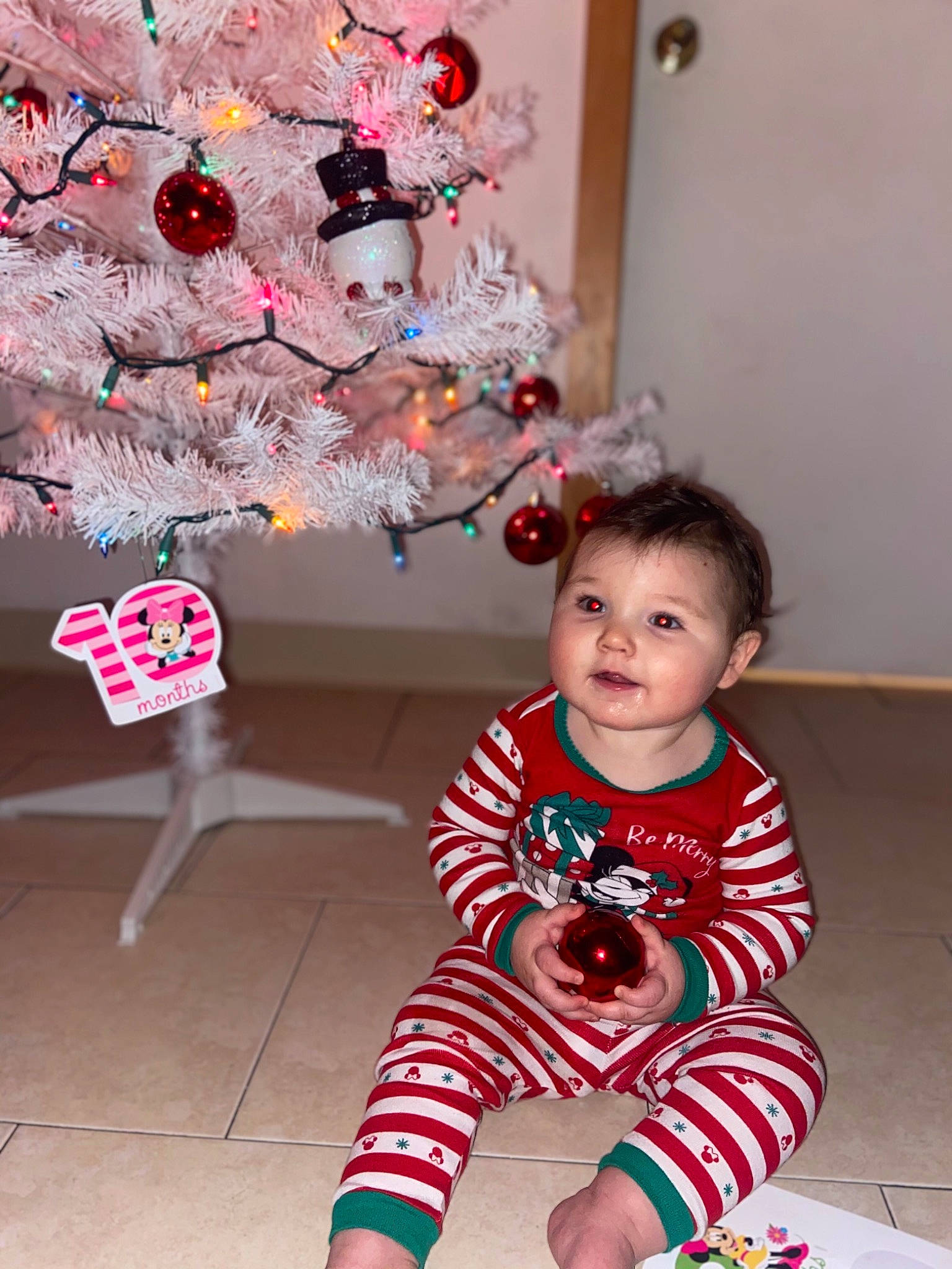 Sophia is registered to the contest to win money with this photo: baby, baby_playing_with_toys, baby_toddler_clothing, baby_toys, christmas, christmas_decoration, christmas_ornament, holiday, holiday_ornament, home, living_room, long_sleeved_t_shirt, nightwear, ornament, pajamas, party_supply, person, play, sock, toddler