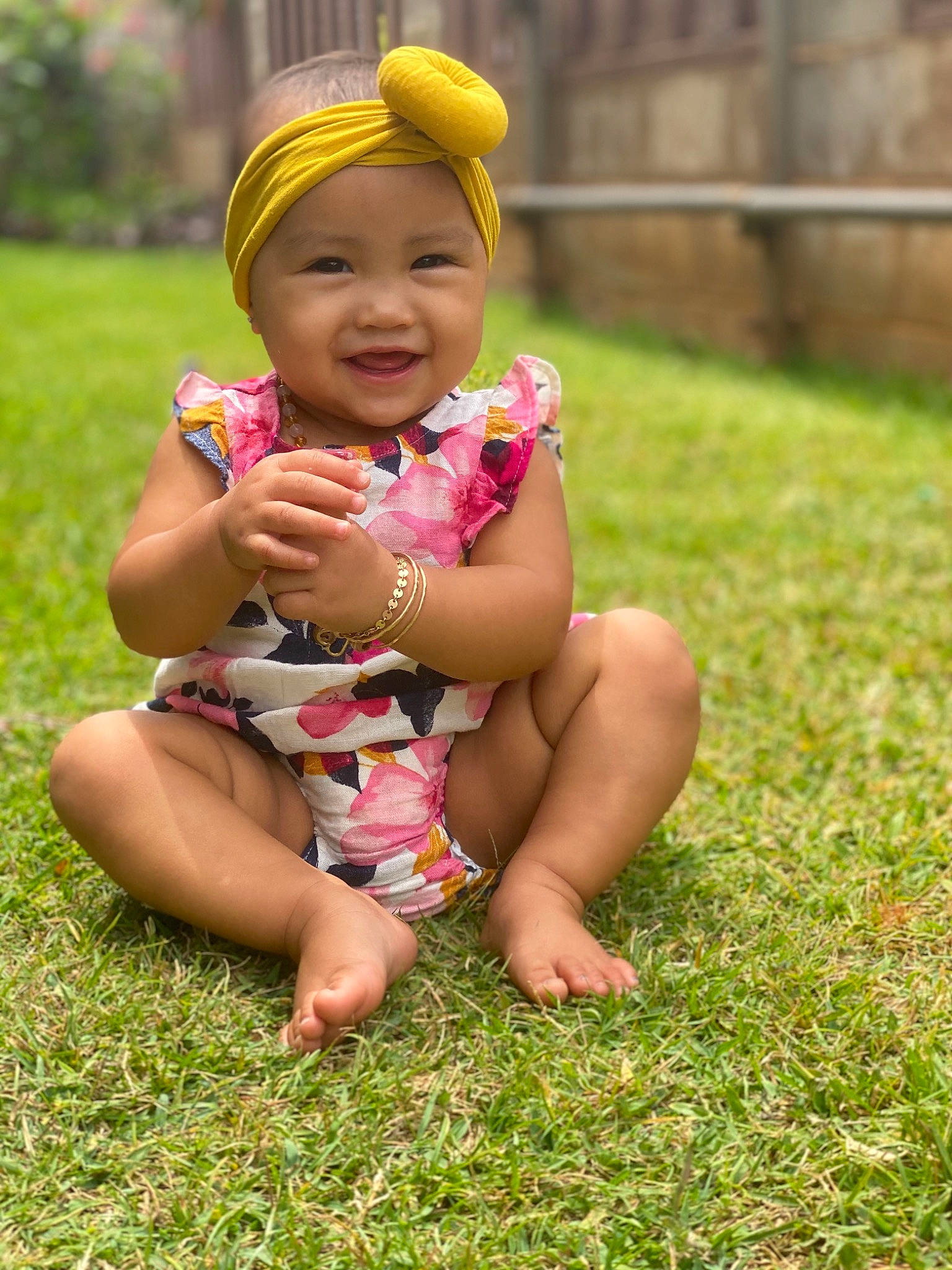 Kailea is registered to the contest to win money with this photo: baby, child, flower, fun, grass, happy, headgear, headwear, joy, meadow, person, pink, plant, play, sitting, smile, toddler