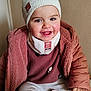 Mélina participe au concours pour gagner de l'argent avec cette photo : child, toddler, beanie, hat, pink_coat, scarf, smile, rosy_cheeks, teeth, sitting, shoe, hand, indoor, portrait, cozy, winter_clothes, cute, jacket, face, happy