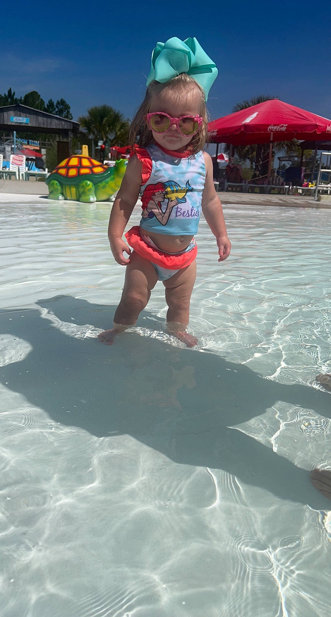 Evelyn Grace joined the competition — help win amazing prizes! barefoot, beach, blue, body_of_water, child, fun, goggles, happy, leisure, people_on_beach, person, personal_protective_equipment, recreation, sand, shorts, sky, smile, summer, toddler, vacation