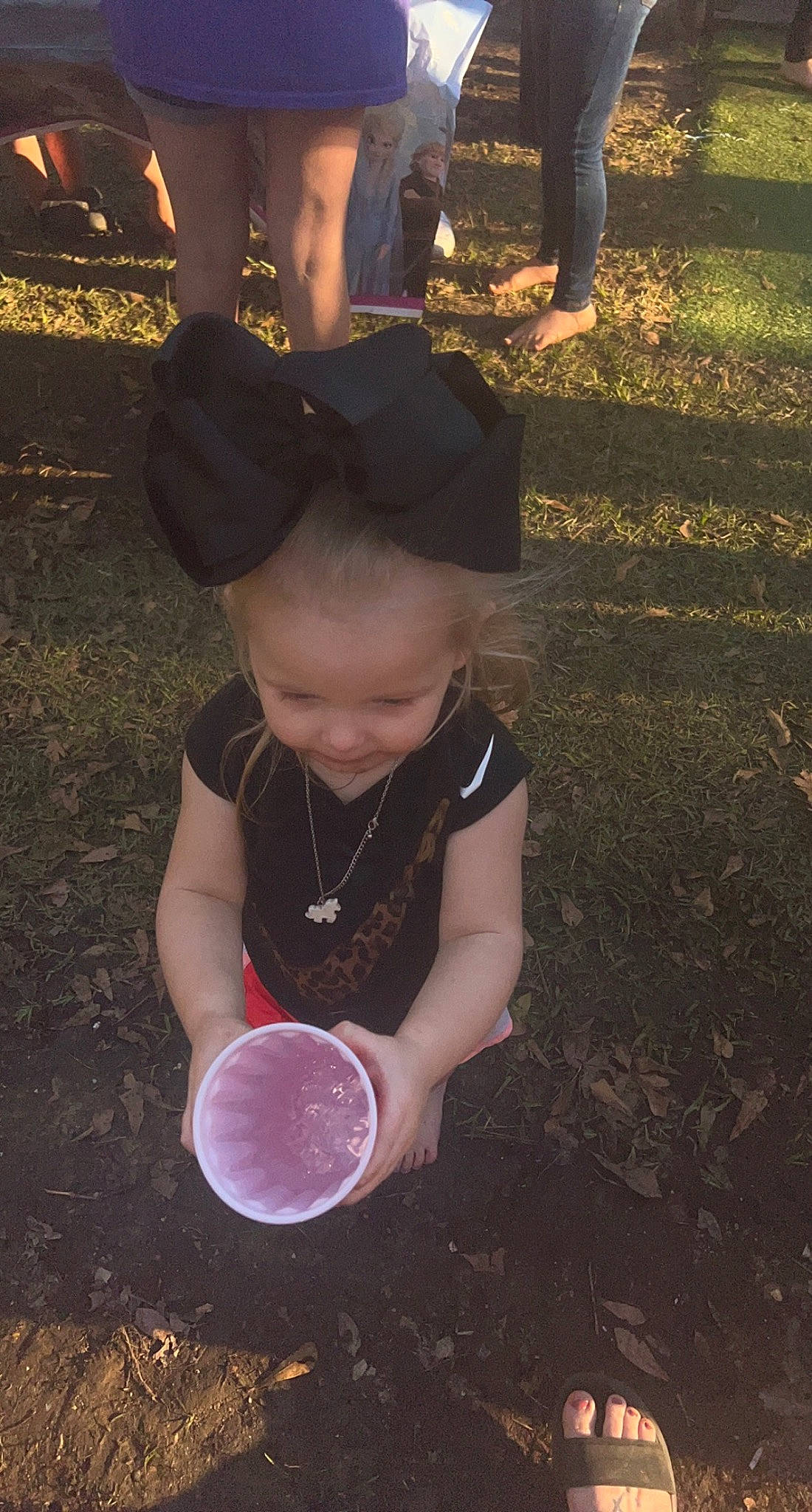 Evelyn Grace is registered to the contest to win money with this photo: baby, baby_toddler_clothing, black, cap, child, fun, gesture, grass, happy, hat, leaf, light, people, people_in_nature, person, photograph, shoe, sunlight, tints_and_shades, toddler