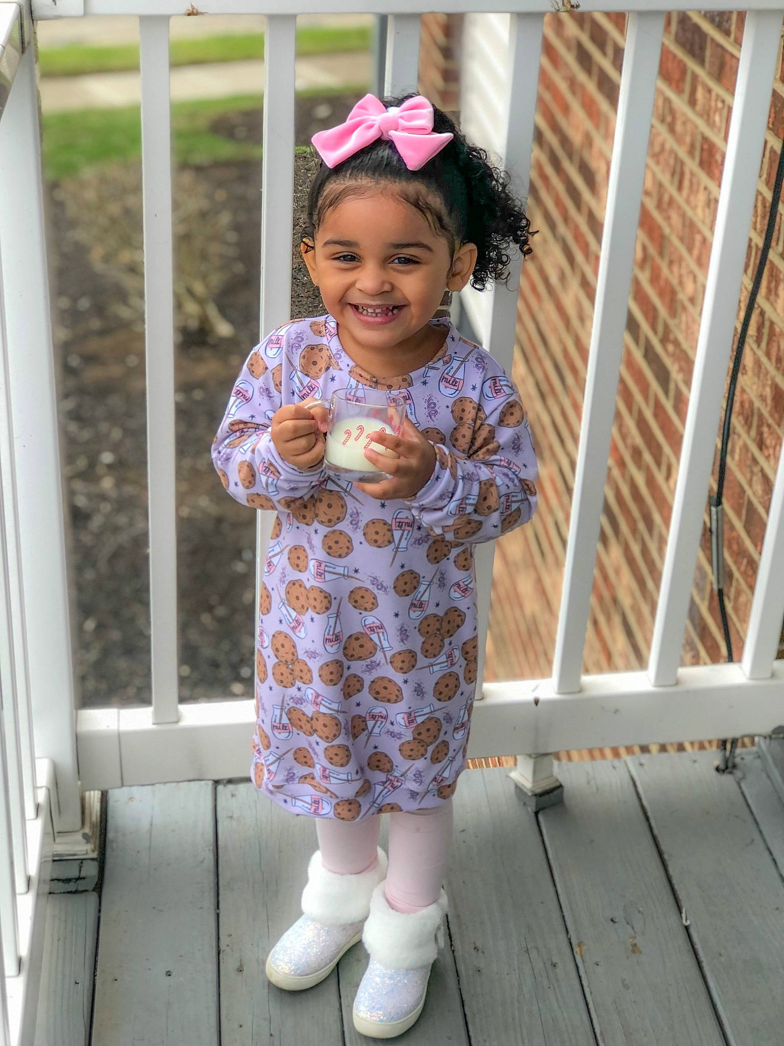 Naomi is registered to the contest to win money with this photo: baby_toddler_clothing, eye, face, footwear, happy, joy, leg, outerwear, pattern, person, pink, purple, sleeve, smile, sneakers, sock, standing, street_fashion, toddler, waist