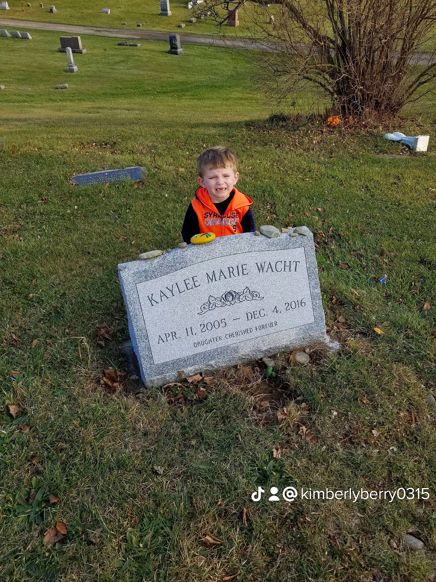 Caleb joined the competition — help win amazing prizes! cemetery, font, garden, grass, grass_family, grassland, grave, groundcover, handwriting, headstone, landscape, landscaping, lawn, leaf, people_in_nature, person, plant, sitting, soil, sorrow