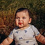 baby, butterfly_pattern, child, cute, daylight, expression, face, funny_face, grass, happy, nature, outdoor, person, portrait, shirt, sitting, skin, sunlight, toddler, young