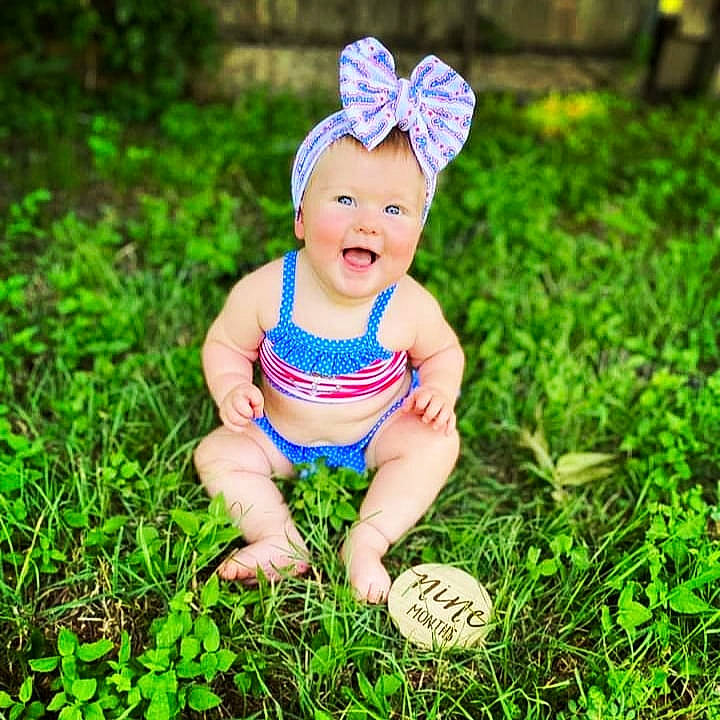 Swayde is registered to the contest to win money with this photo: baby, baby_toddler_clothing, costume_hat, electric_blue, flash_photography, grass, grass_family, grassland, green, groundcover, happy, hat, headpiece, lawn, leaf, meadow, people_in_nature, person, plant, smile