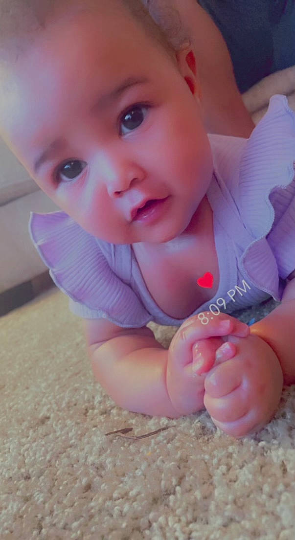 Malayiah is registered to the contest to win money with this photo: baby, baby_toddler_clothing, cheek, child, eye, finger, gesture, hand, happy, leg, lip, nail, nose, person, pink, sitting, skin, sleeve, smile, thumb