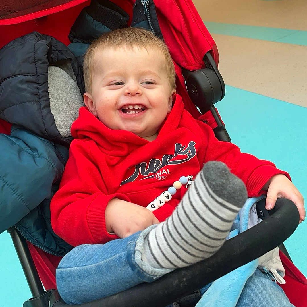 Ayden participe au concours pour gagner de l'argent avec cette photo : baby, bodypart, clothing, coat, cushion, face, happy, head, homedecor, hosiery, jacket, jeans, laughing, pants, person, photography, portrait, sock, stroller, t_shirt