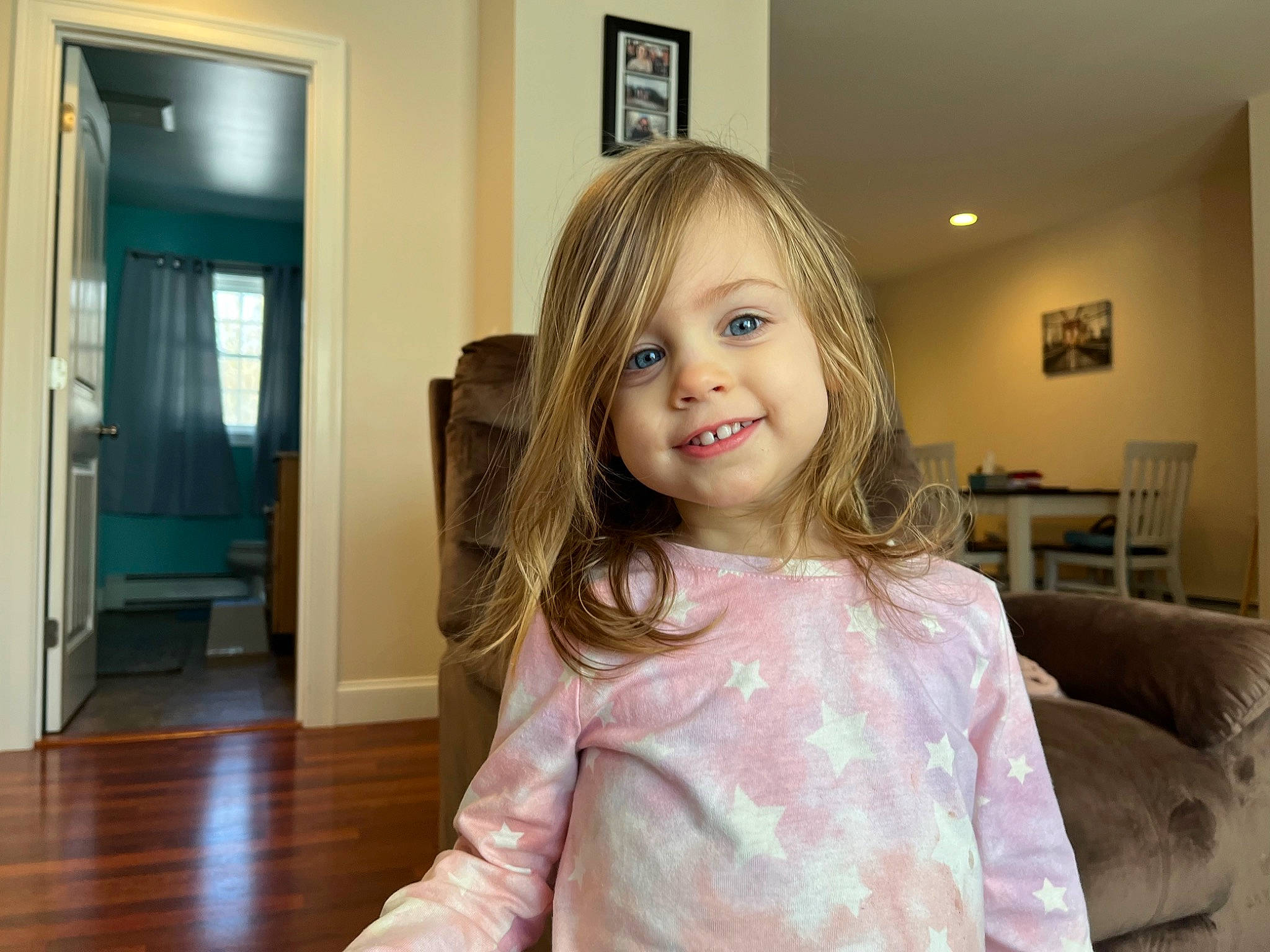 Celia is registered to the contest to win money with this photo: blond, child, couch, door, dress, floor, flooring, fun, hairstyle, happy, hardwood, house, iris, joy, person, picture_frame, shoulder, skin, sleeve, smile