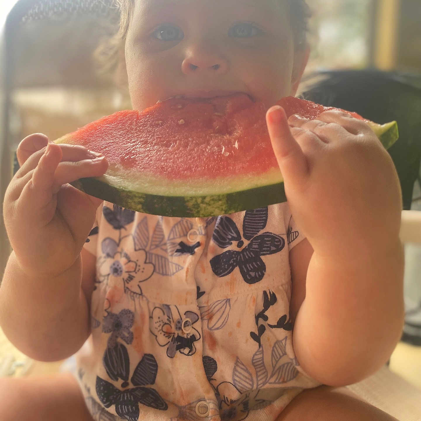 Mavis joined the competition — help win amazing prizes! baby, child, closeup, clothing, cute, eating, face, floral_pattern, food, fruit, hands, happy, indoor, juice, messy, portrait, sitting, summer, toddler, watermelon