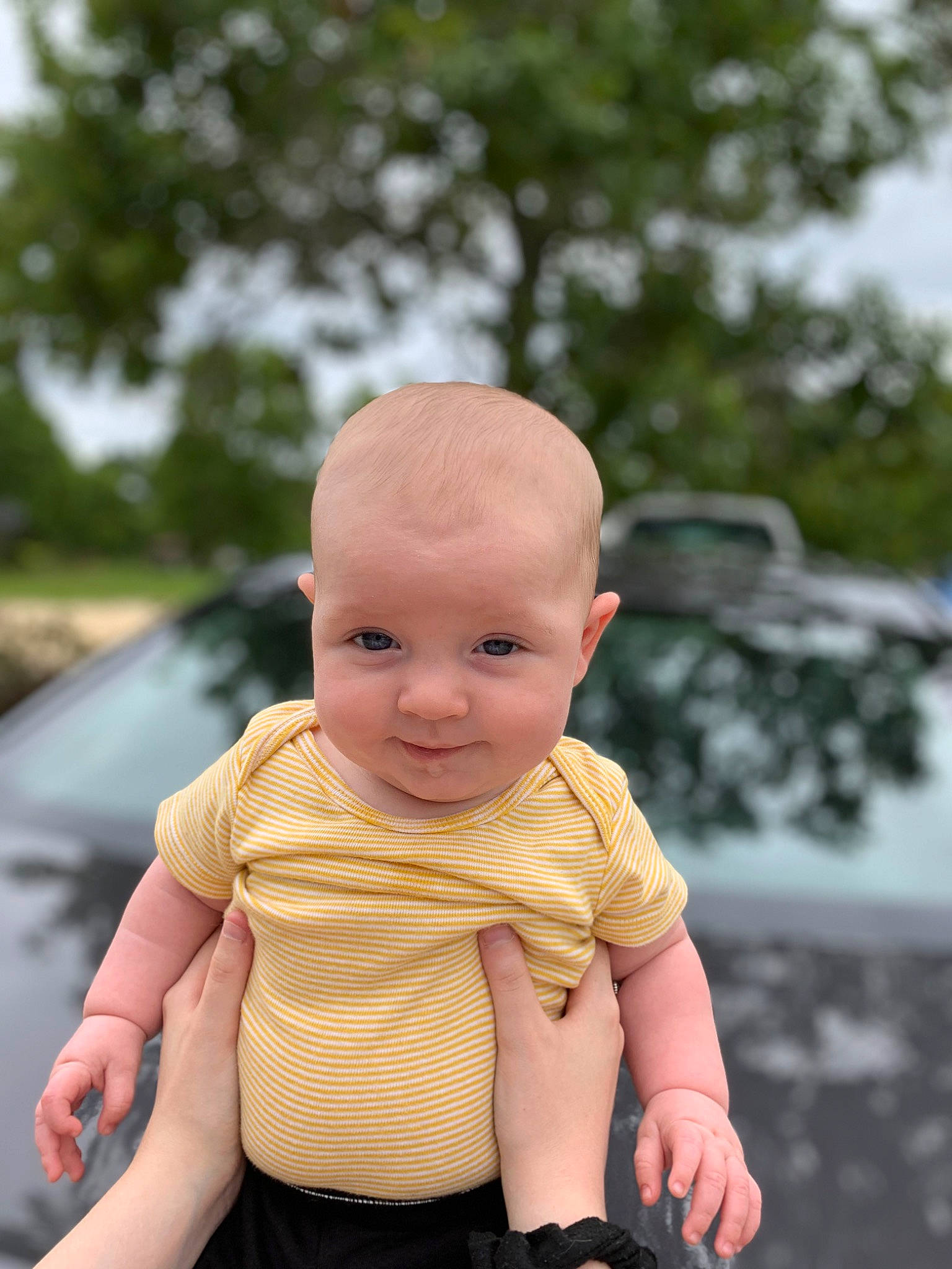 Jazper is registered to the contest to win money with this photo: baby, baby_toddler_clothing, cheek, finger, fun, gesture, grass, happy, hat, leisure, person, recreation, sitting, skin, sleeve, smile, thumb, toddler, toy, tree