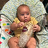 Amari joined the competition — help win amazing prizes! baby, infant, child, portrait, sitting, chair, blanket, cushion, indoor, home, yellow_clothing, cup, drinkware, harley_davidson, colorful, cozy, curious, barefoot, smiling, photography