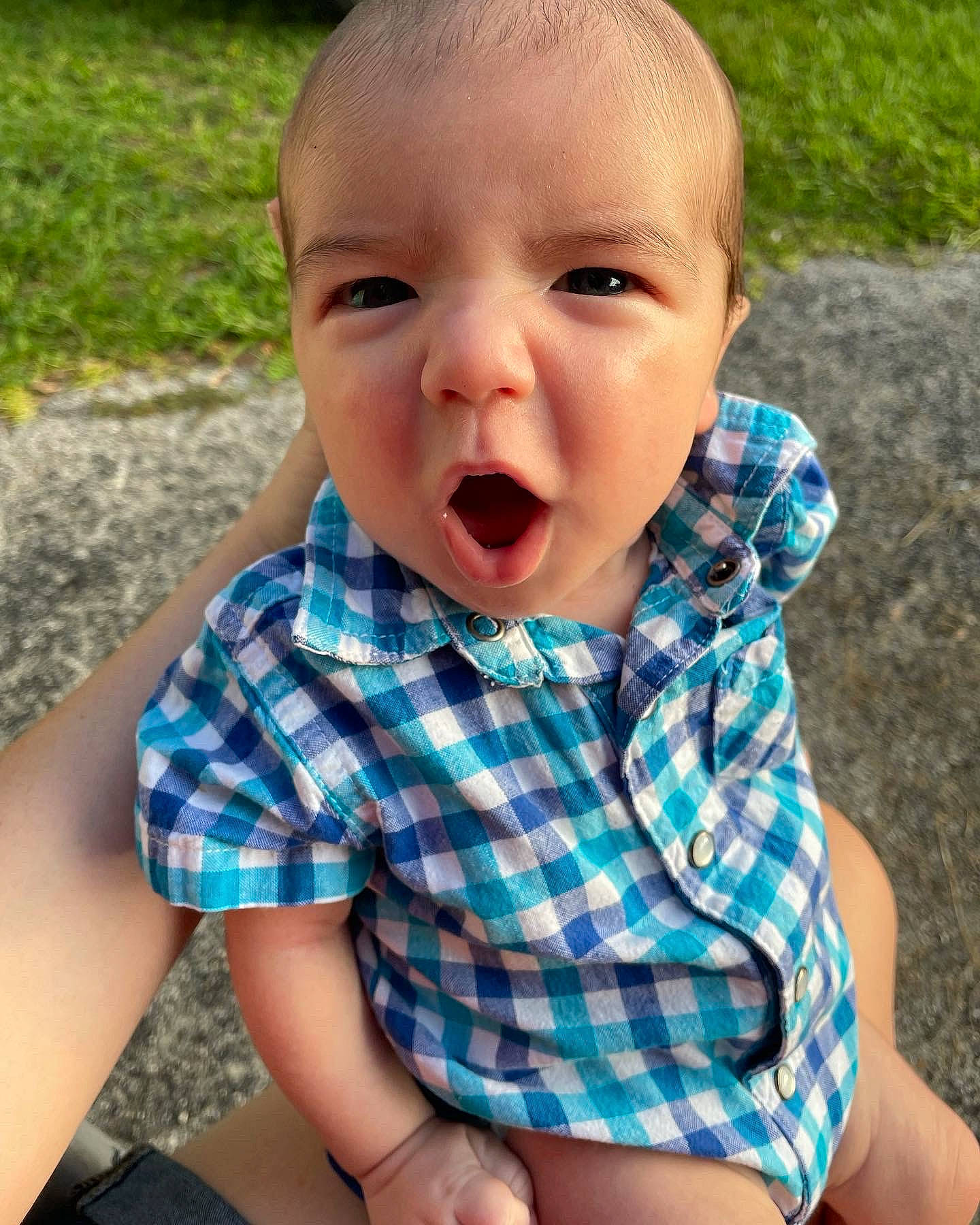 Issac is registered to the contest to win money with this photo: baby, baby_toddler_clothing, cheek, collar, dress_shirt, eye, fun, grass, happy, head, iris, lip, mouth, nose, pattern, person, plaid, skin, sleeve, summer
