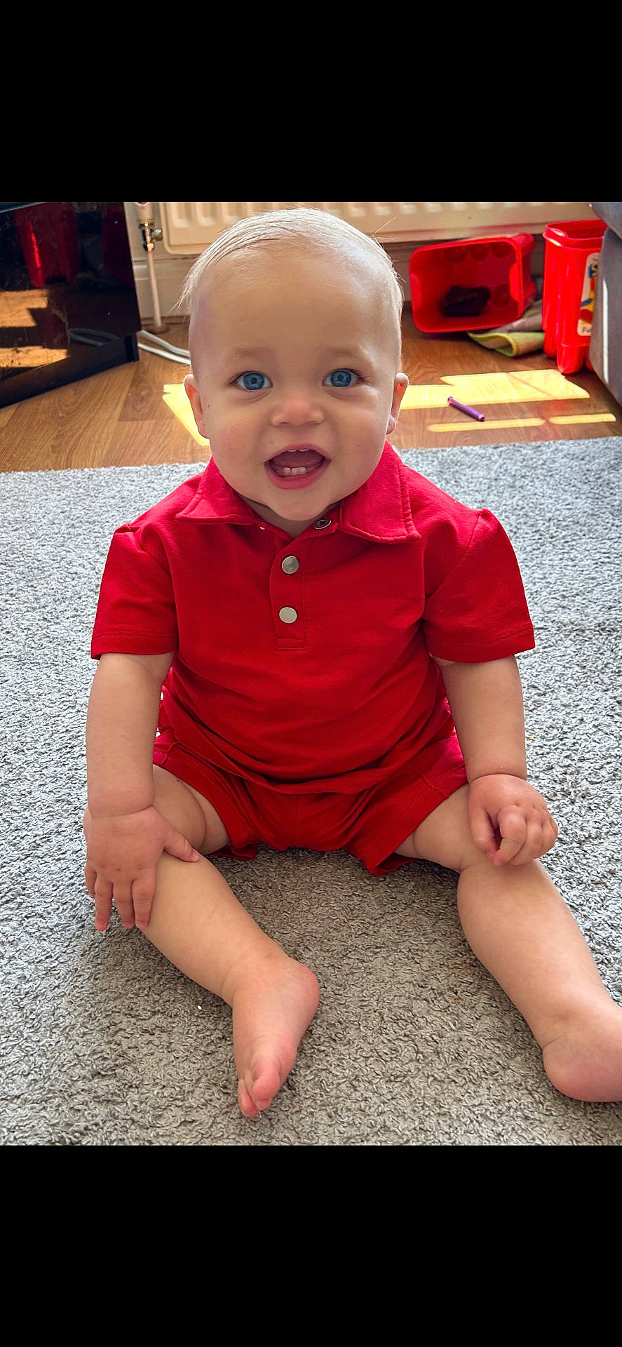 Ronnie joined the competition — help win amazing prizes! baby, bodypart, clothing, dress, face, finger, hand, happy, hardwood, head, indoors, pants, pen, person, photography, portrait, shorts, sitting, smile, wood