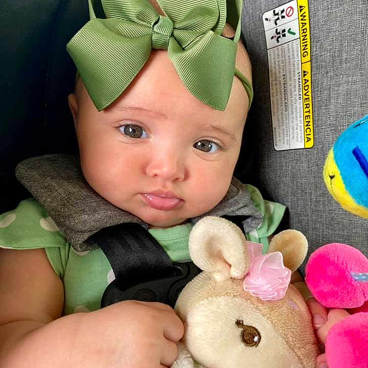 Elizabeth is registered to the contest to win money with this photo: baby, baby_toddler_clothing, cap, cheek, costume_hat, ear, eye, finger, green, happy, head, headgear, headpiece, pink, product, skin, snapshot, textile, toddler, toy