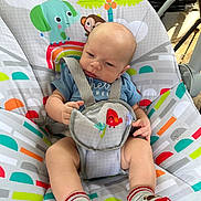 Thomas is registered to the contest to win money with this photo: baby, infant, child, baby_seat, colorful, animal_print, rainbow, socks, blue_shirt, cute, indoors, seat_belt, toddler, playful, patterned_fabric, baby_toys, comfort, young_child, portrait, casual