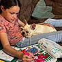 girl, dog, french_bulldog, couch, coloring_book, marker, art, child, relaxing, indoor, casual_clothing, jeans, pink_shirt, drawing, resting, pet, lap, pillow, home, cozy