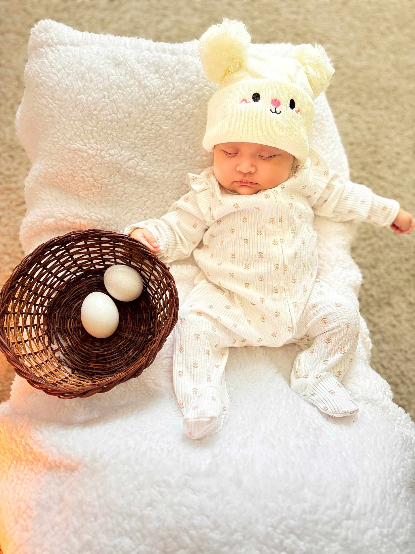 Adhara Luciana is registered to the contest to win money with this photo: baby, sleeping, hat, onesie, basket, eggs, blanket, carpet, soft_texture, cozy, cute, indoor, child, infant, resting, wearing, headwear, white, peaceful, adorable