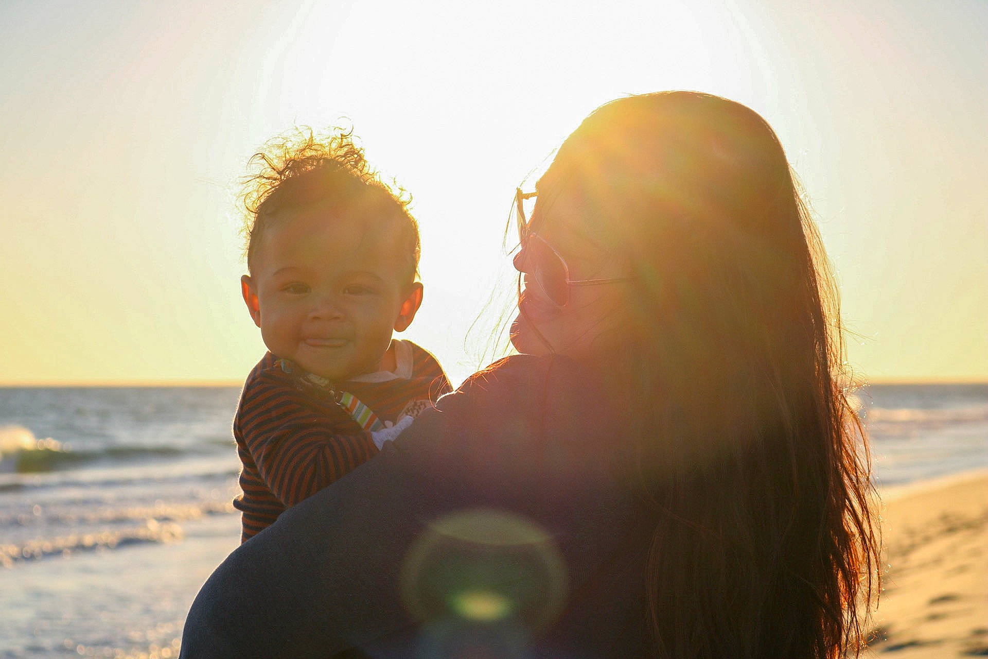 Hakeem is registered to the contest to win money with this photo: backlighting, beach, child, fun, happy, interaction, lens_flare, light, love, ocean, person, photograph, photography, sand, sea, sky, summer, sunlight, toddler, vacation