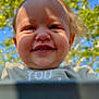 toddler, child, smile, face, outdoor, sunlight, blue_sky, green_leaves, nature, happy, portrait, baby, person, head, clothing, daylight, cute, expression, closeup, young