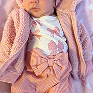 Milani joined the competition — help win amazing prizes! baby, infant, pink_clothing, headband, bow, blanket, cute, portrait, soft_texture, child, newborn, cozy, apparel, face, eyes, sitting, indoors, warm, young, person