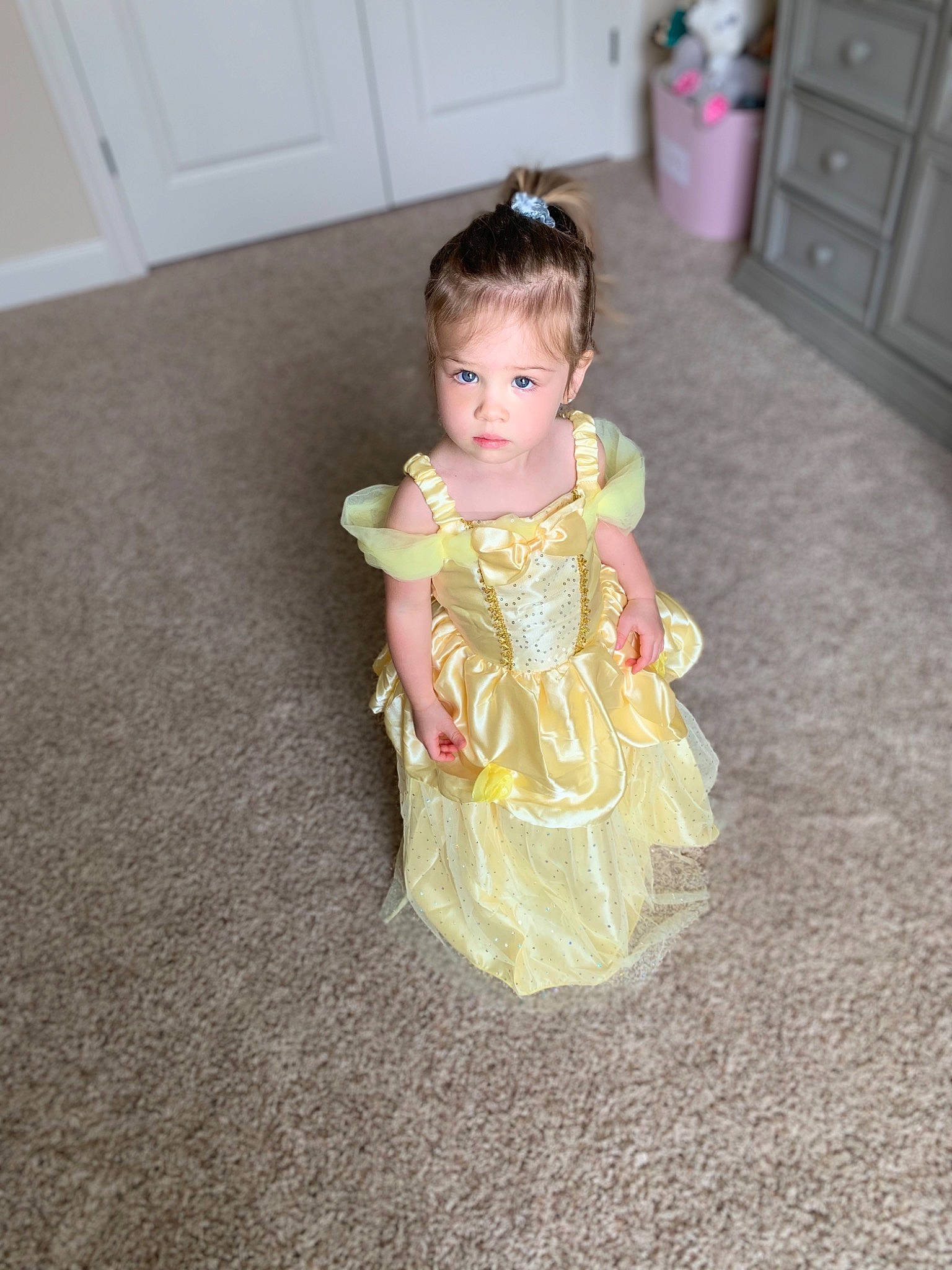 Kairi is registered to the contest to win money with this photo: baby, child, costume, dress, floor, flooring, iris, person, pink, room, sitting, skin, textile, toddler, yellow