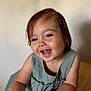 toddler, child, smiling, portrait, blue_eyes, dress, short_hair, indoor, wooden_table, happy, cute, baby, skin, face, person, young_child, candid, expression, closeup, natural_light