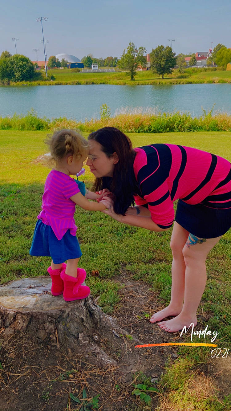 Larissa is registered to the contest to win money with this photo: fun, grass, grassland, green, happy, lake, landscape, leisure, magenta, nature, people_in_nature, person, pink, plant, shorts, sky, summer, t_shirt, toddler, tree
